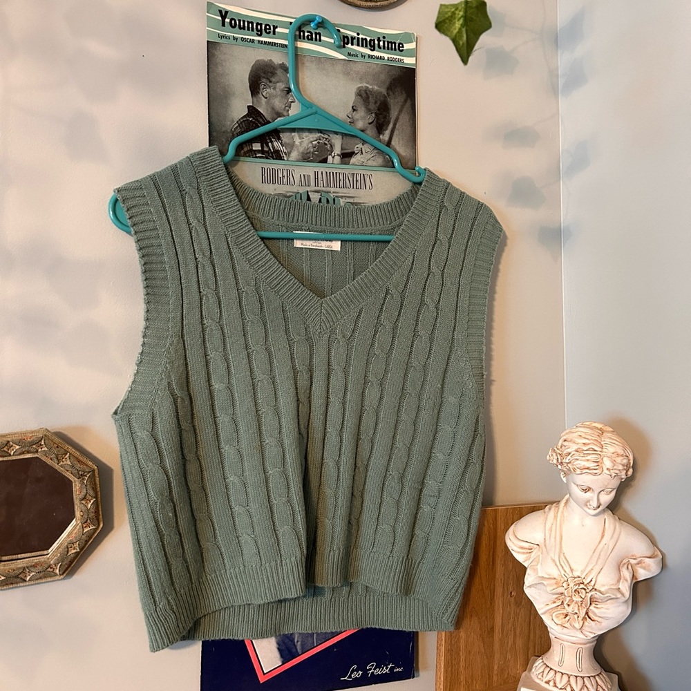 a large dark kinda forest green vest thrifted the brand is “full circle trends”